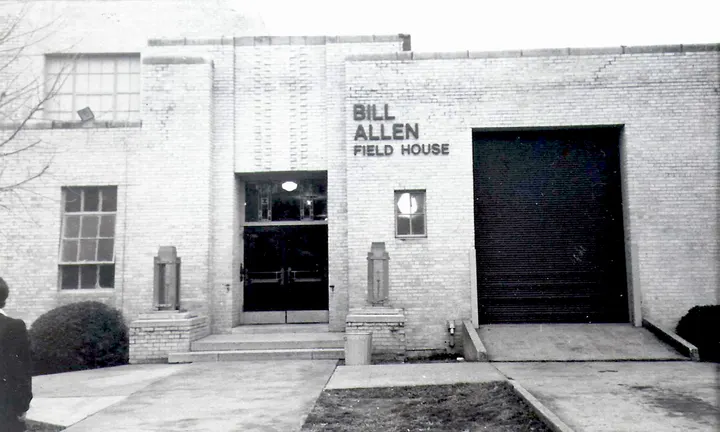 The brick entrance of a building with the sign Bill Allen Field House.