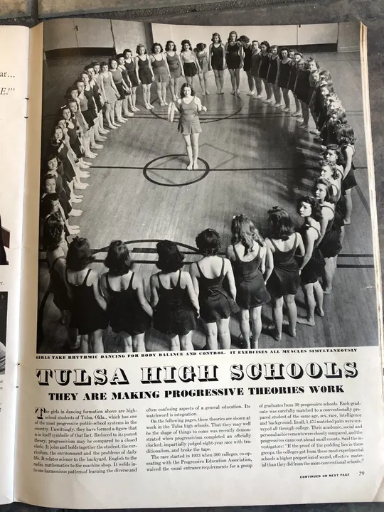 The opening article page with a photograph of students arranged in a circle for a dance class.